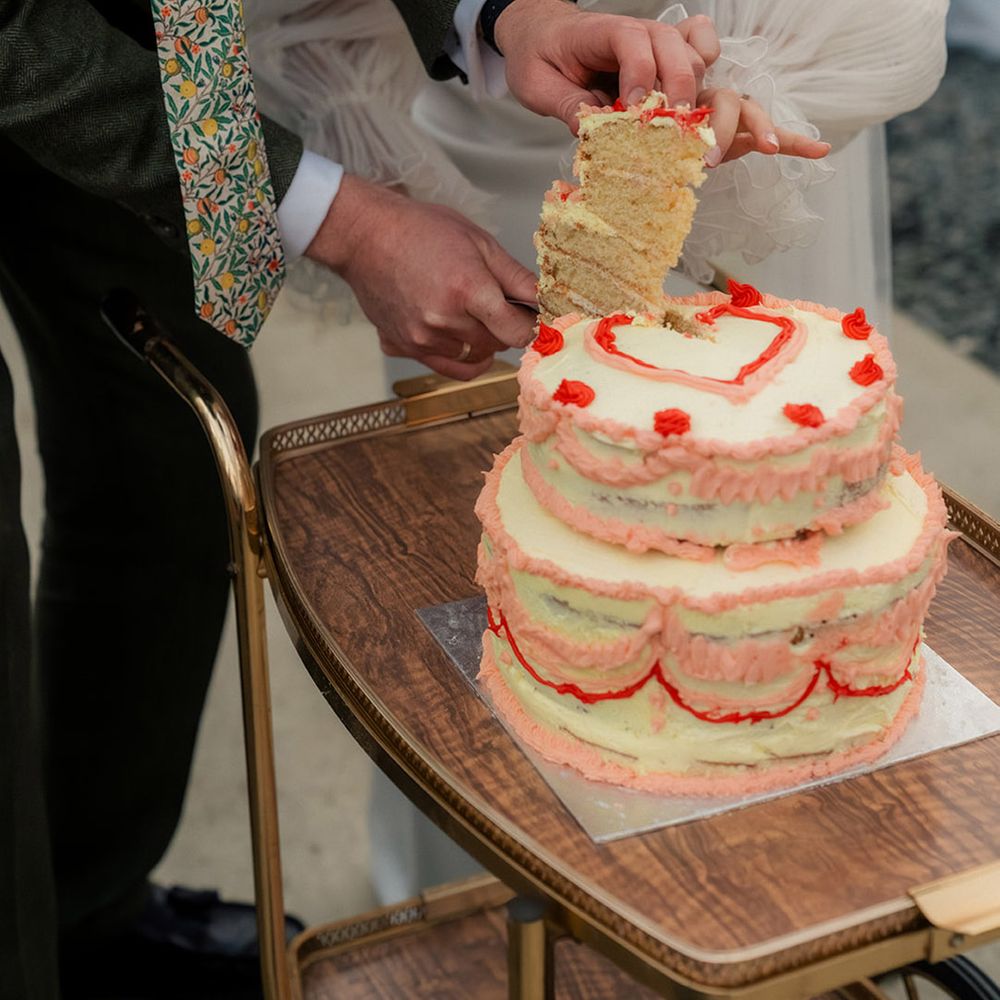 couple-cuts-wedding-cake