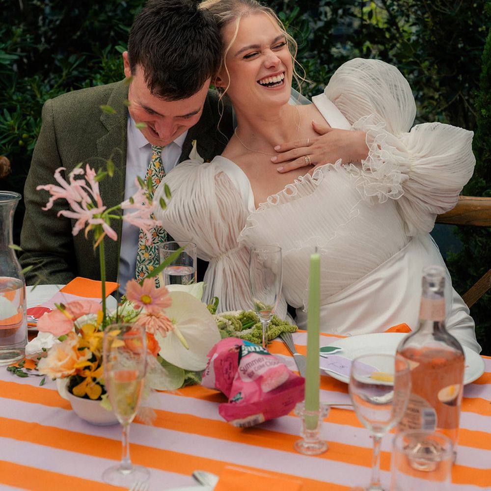 couple-laughing-at-their-wedding-breakfast