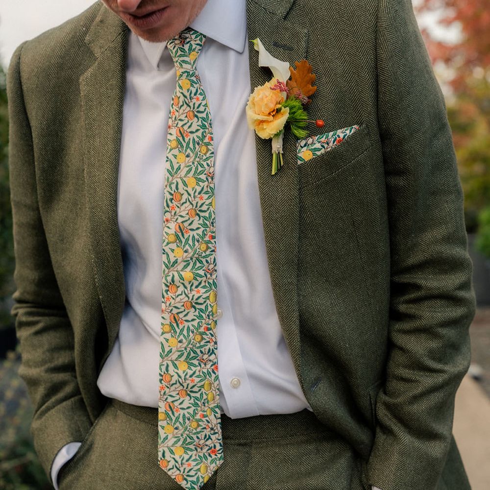 groom-in-dark-green-suit-with-floral-botanical-tie