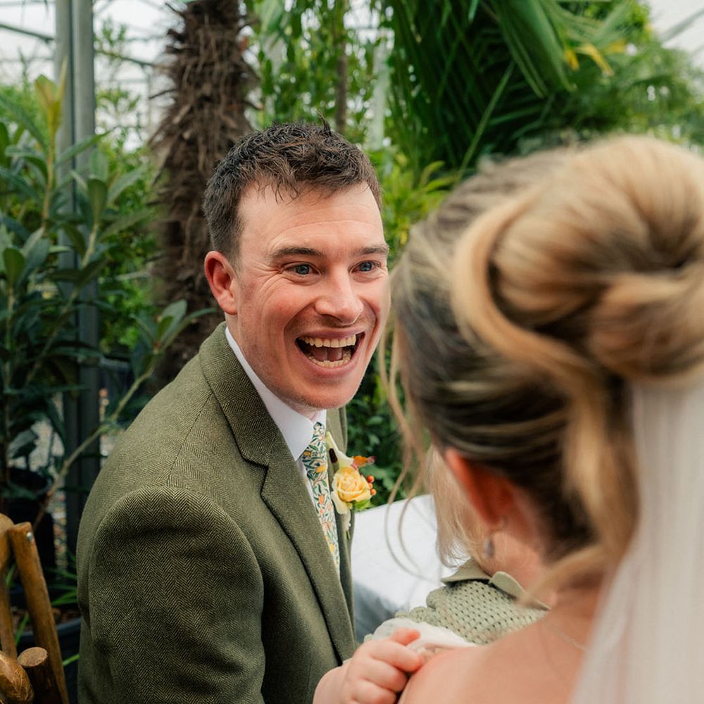groom-smiles-seeing-bride-and-baby