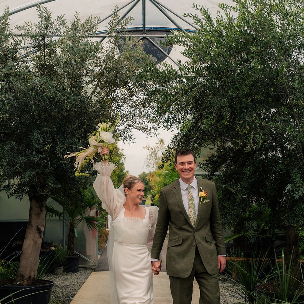 groom-walks-hand-in-hand-with-bride