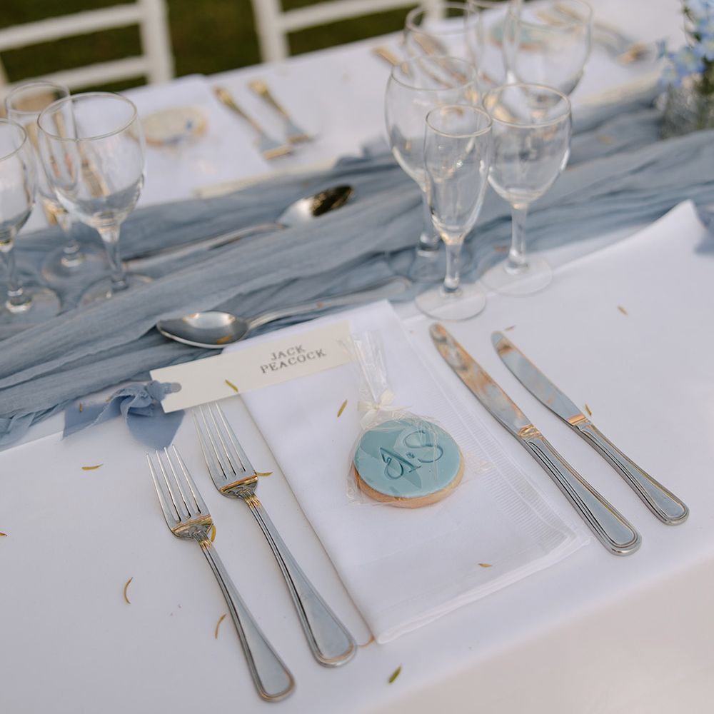 Blue iced wedding biscuit favour with simple place setting