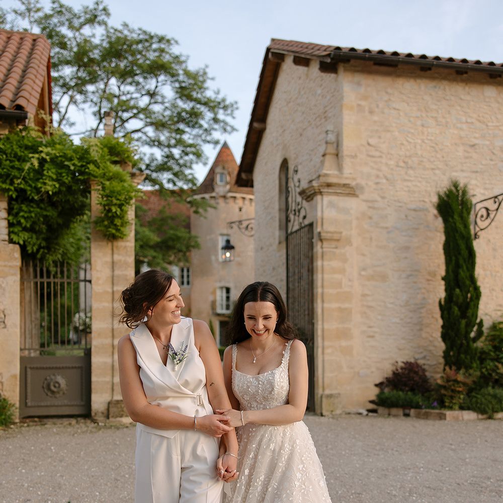 Bride in waistcoat with bride in floral wedding dress
