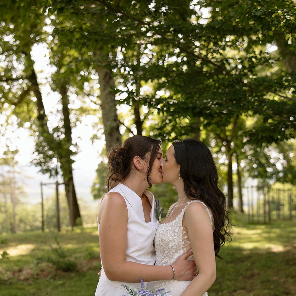 Brides kiss during their couple portrait session
