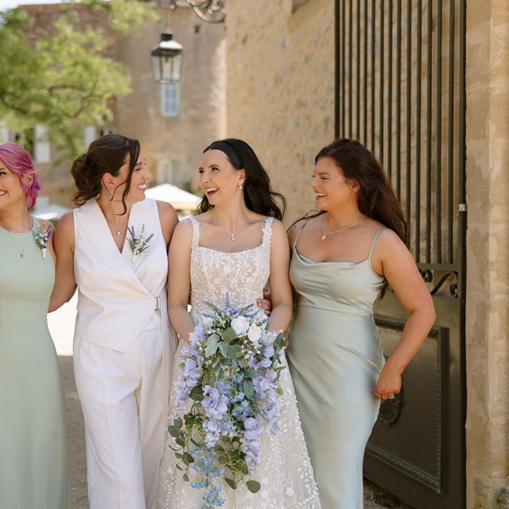 Brides walking with their bridal party in pink and green bridesmaid dresses
