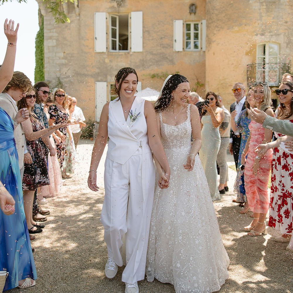 Confetti exit for two brides after outdoor ceremony