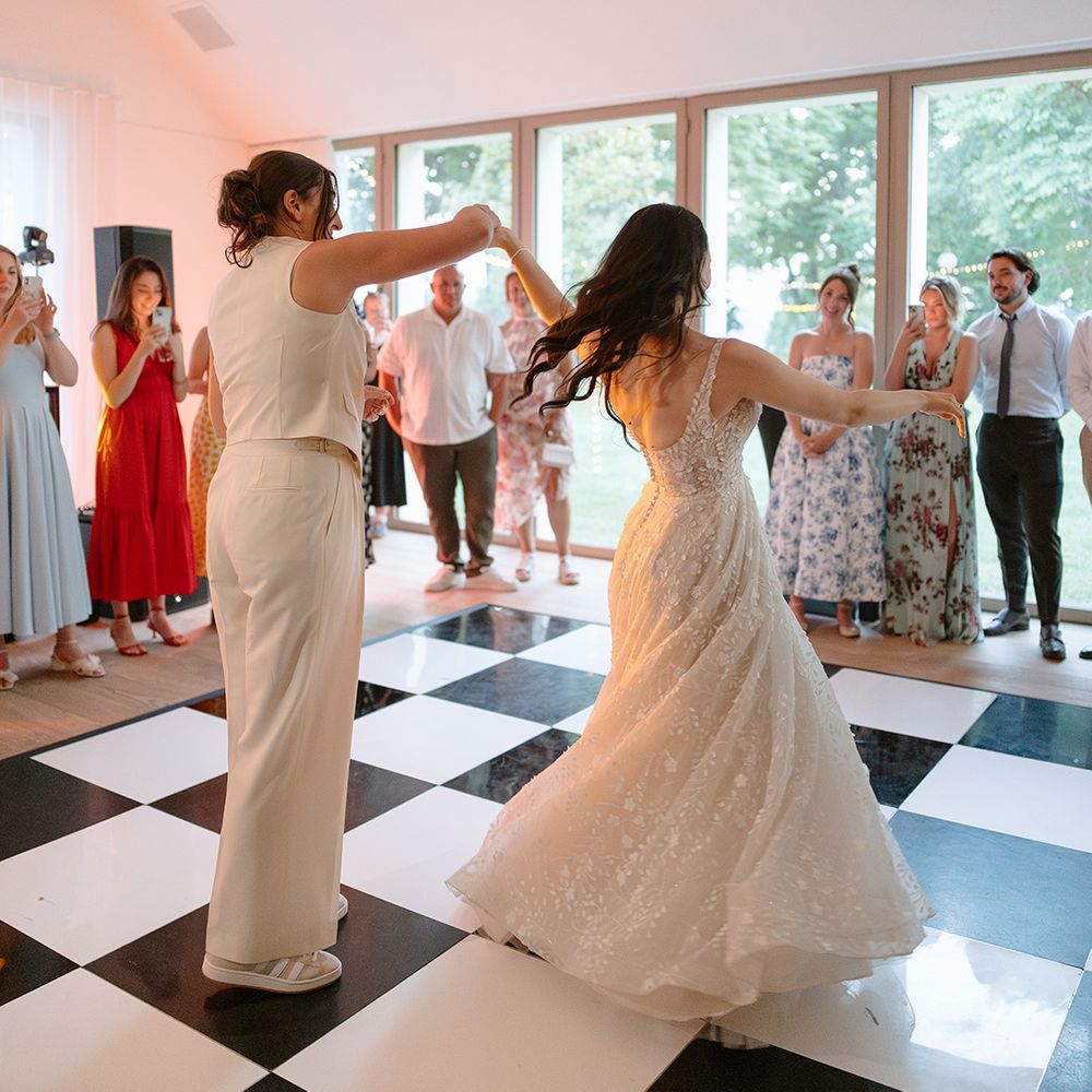 Couple first dance on checkered dance floor 