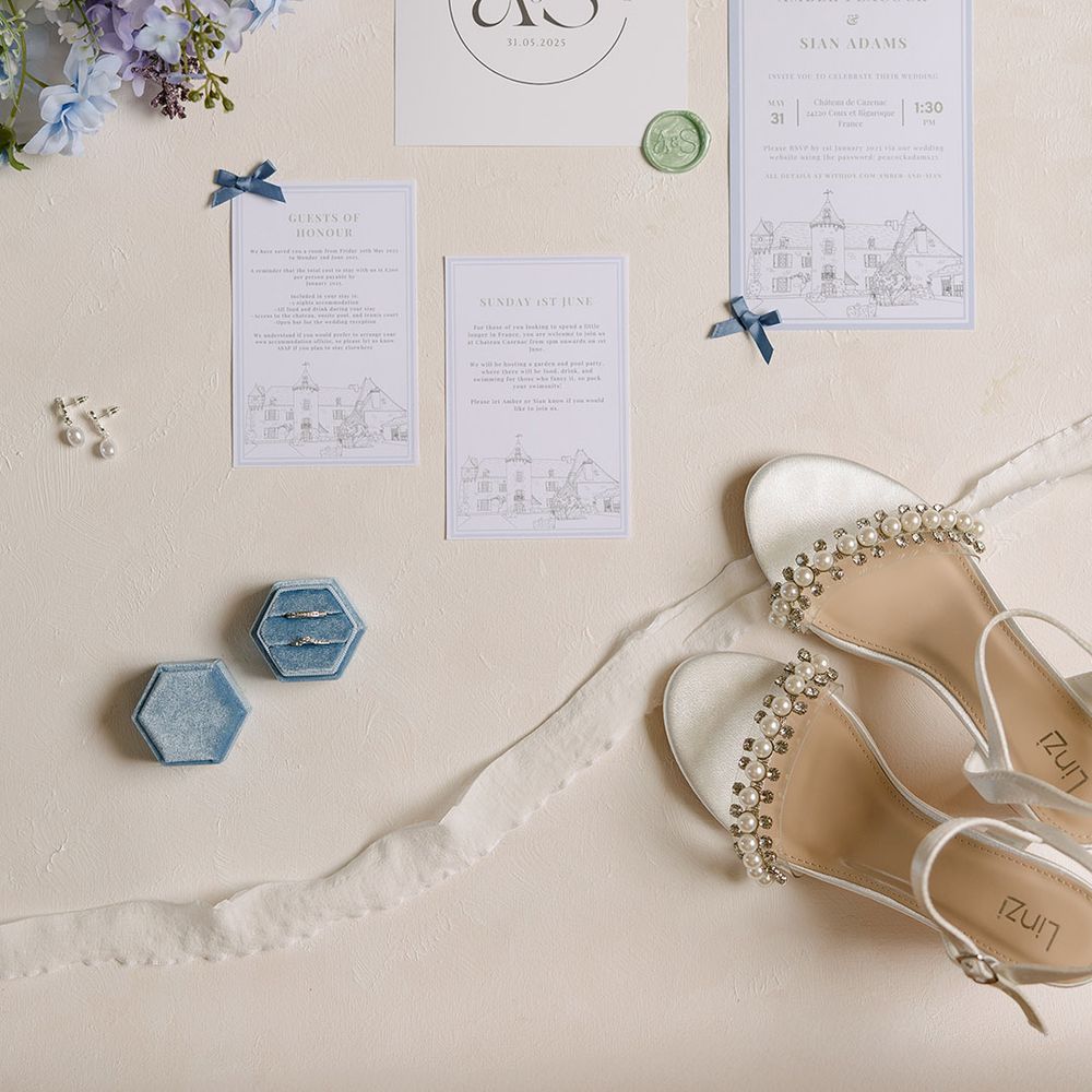 Wedding stationery suite with blue accents and pearl bridal shoes