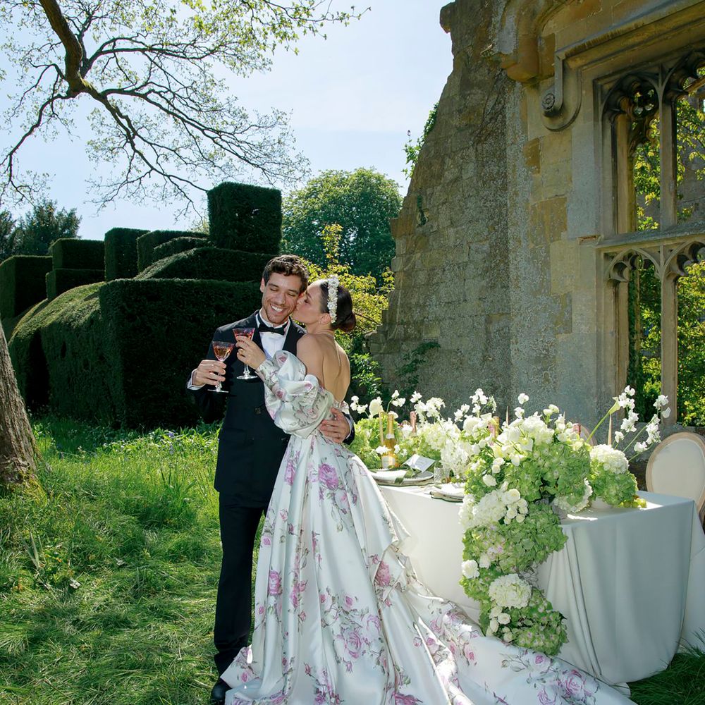 White spring wedding dress with train and pink floral pattern