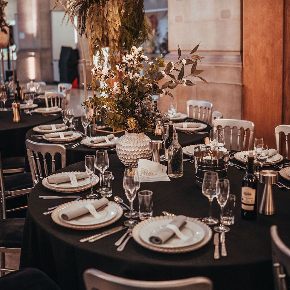 Black wedding tablecloth decorating serpentine tables