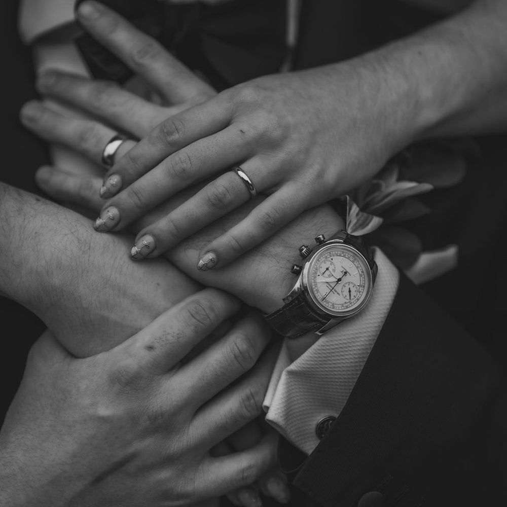 Bride and groom wearing classic wedding rings 