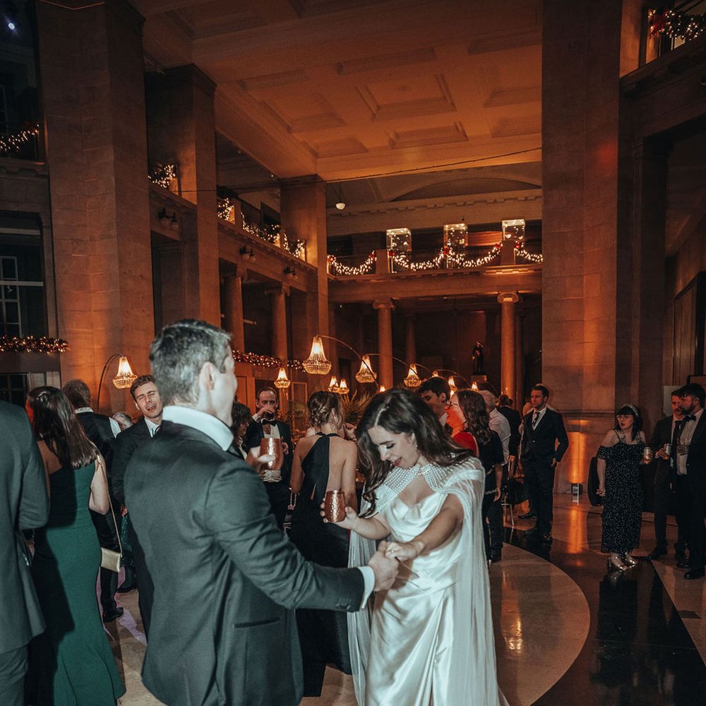 Bride wearing unique beaded cape for reception 