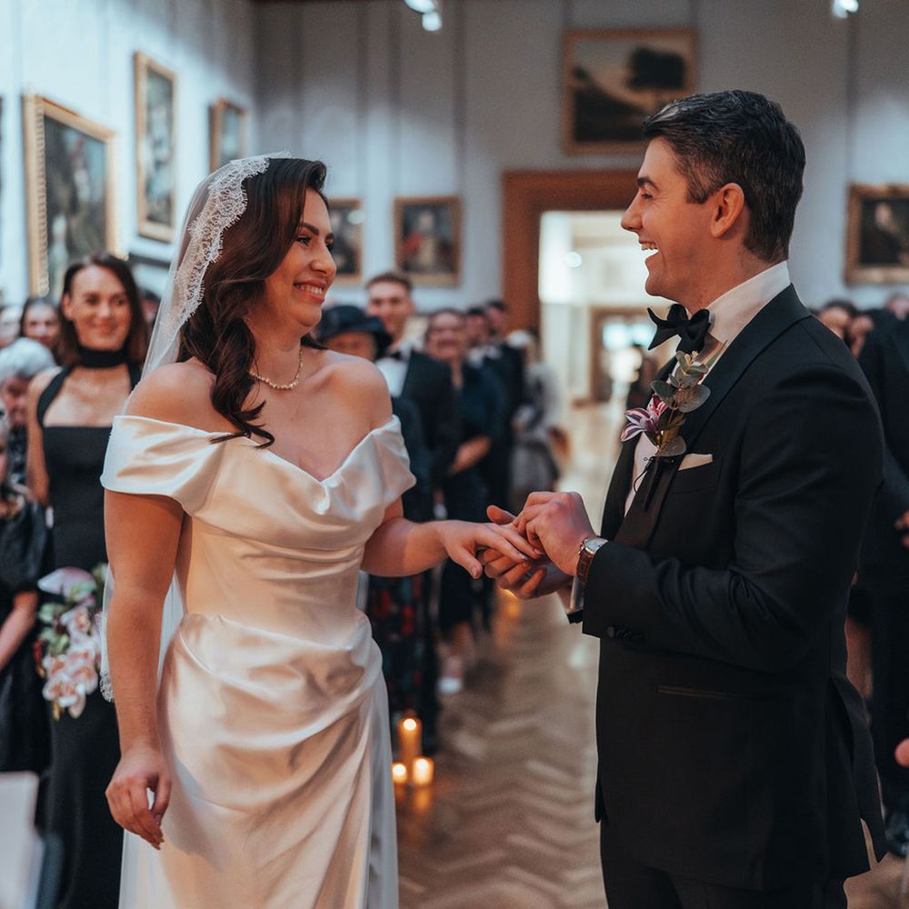 Couples smiling as they meet at the end of the aisle 
