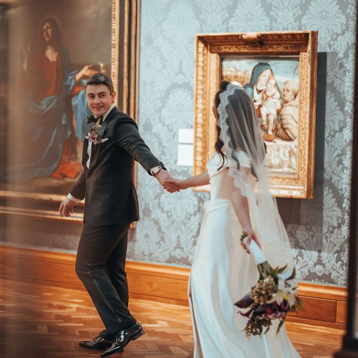 Couple walking hand in hand around museum