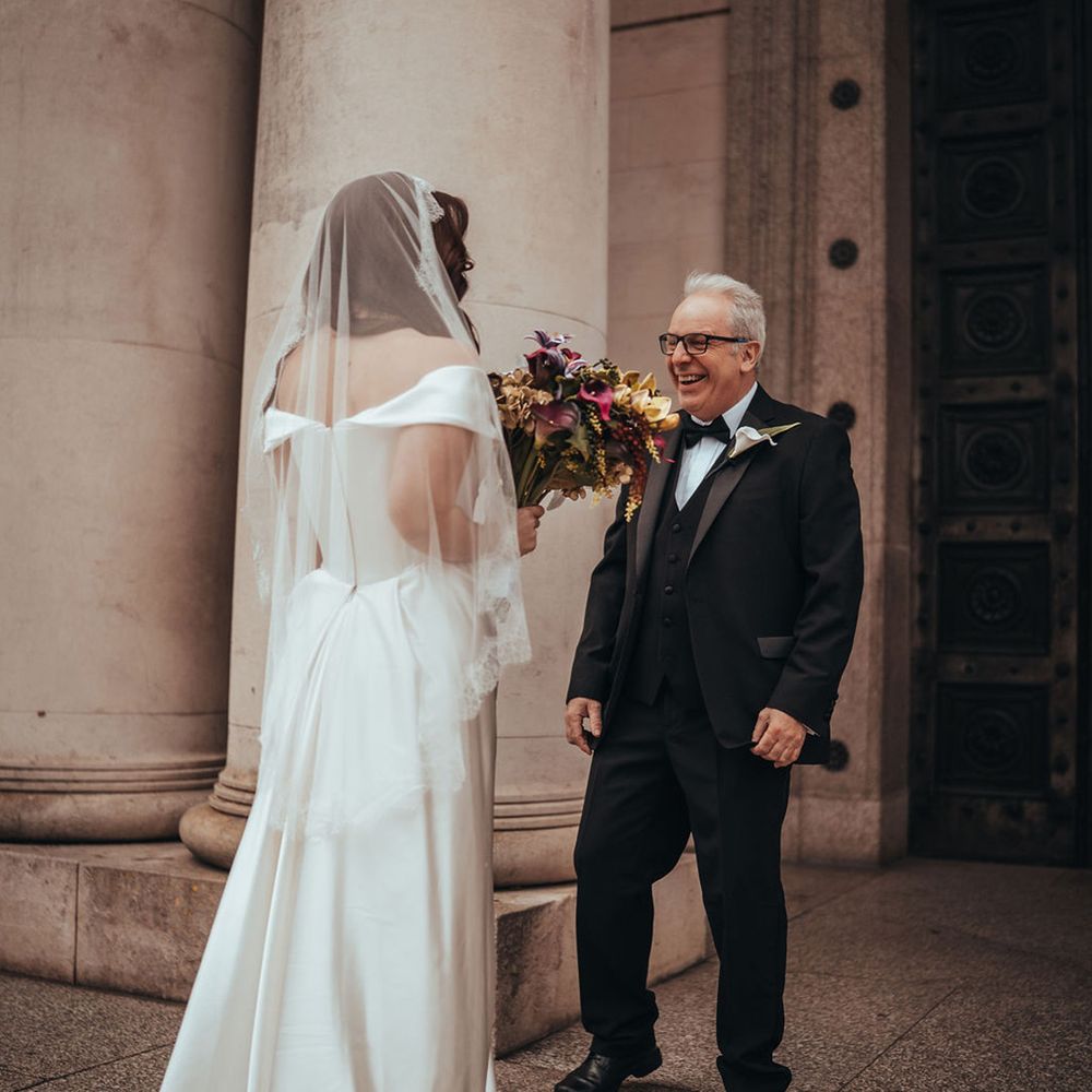 Father of the bride greets the bride 