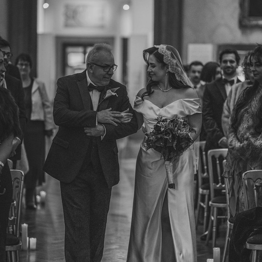 Bride walked down the aisle by her father 