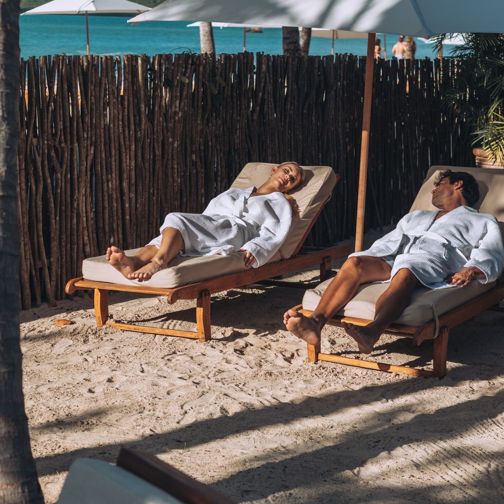 Hermitage Bay beach with sun loungers