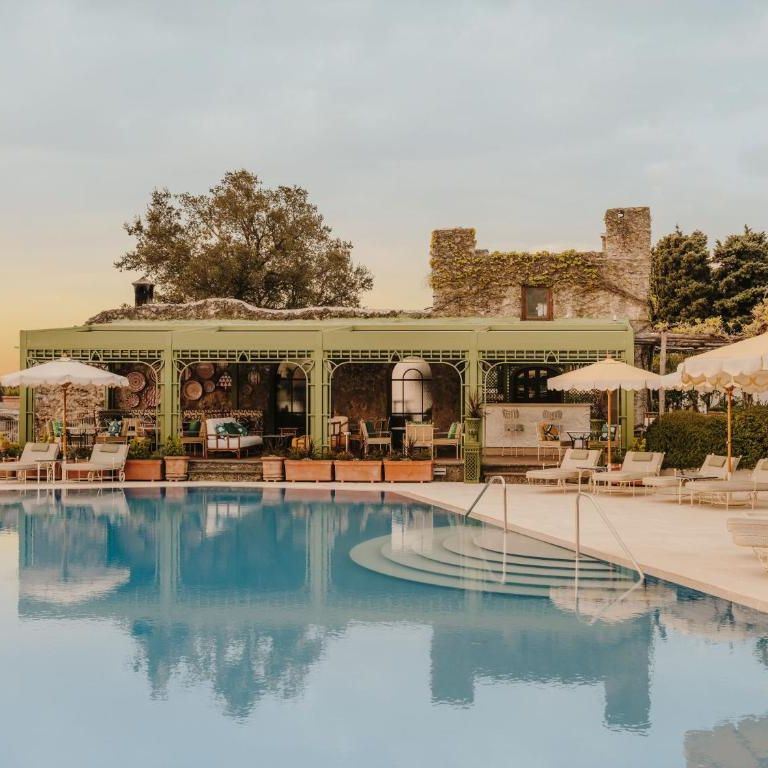 Belmond Hotel pool area with cream umbrellas 