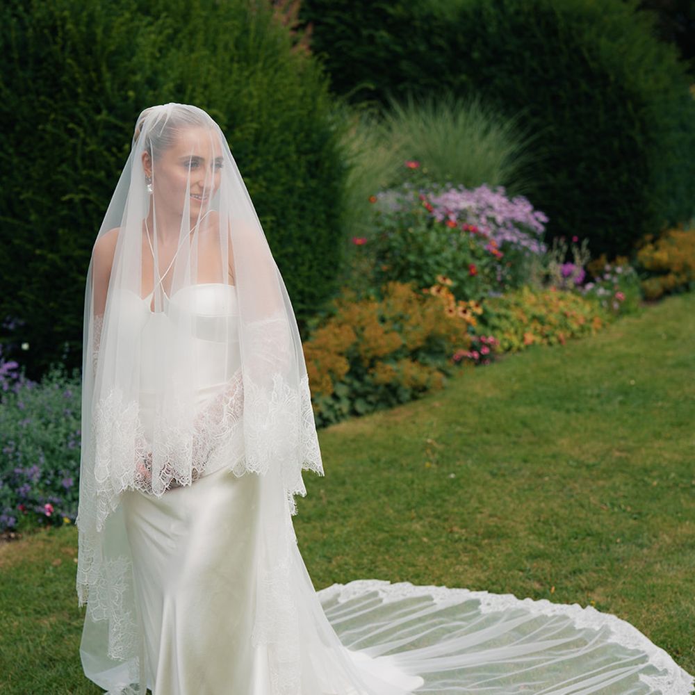 bride in halter neck wedding dress with lace edge wedding veil
