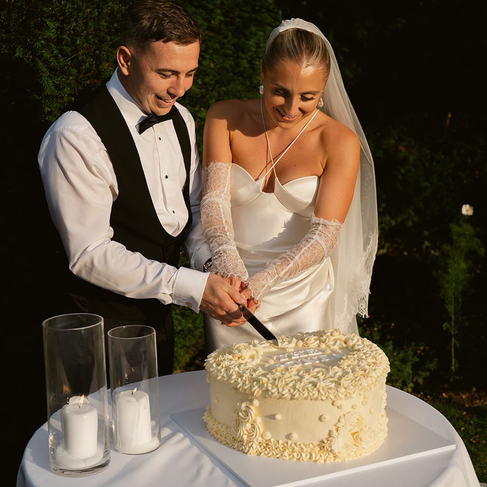 Couple cuts their heart shaped wedding cake 