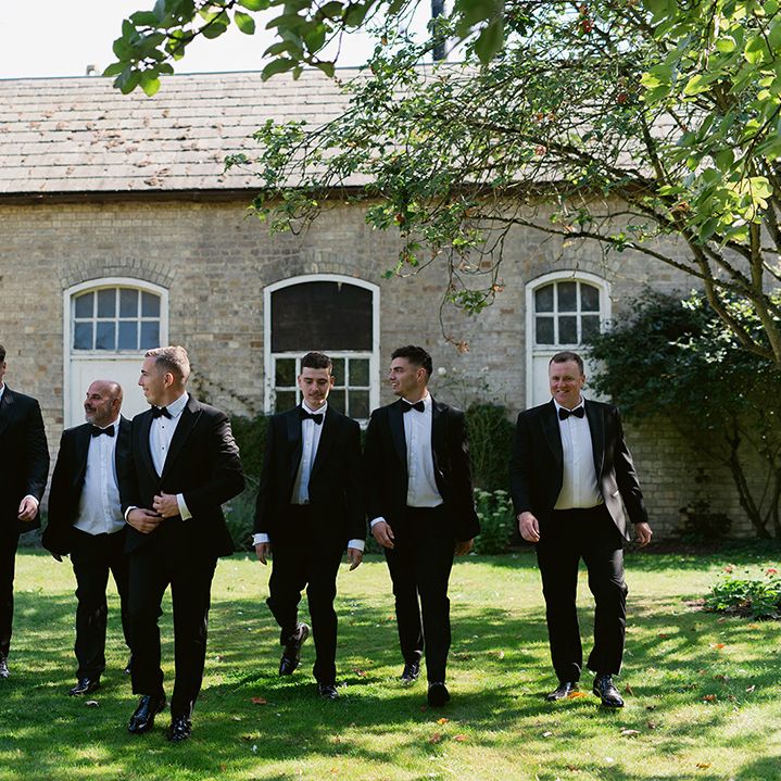 Groom and groomsmen in black tuxedos 