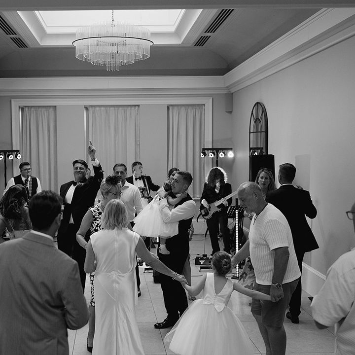 Couples and guests dancing at the wedding reception 