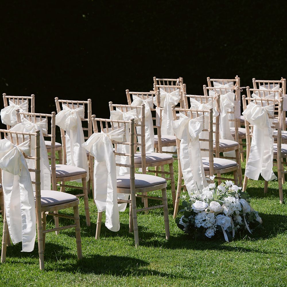 White bow chair decorations with white flowers
