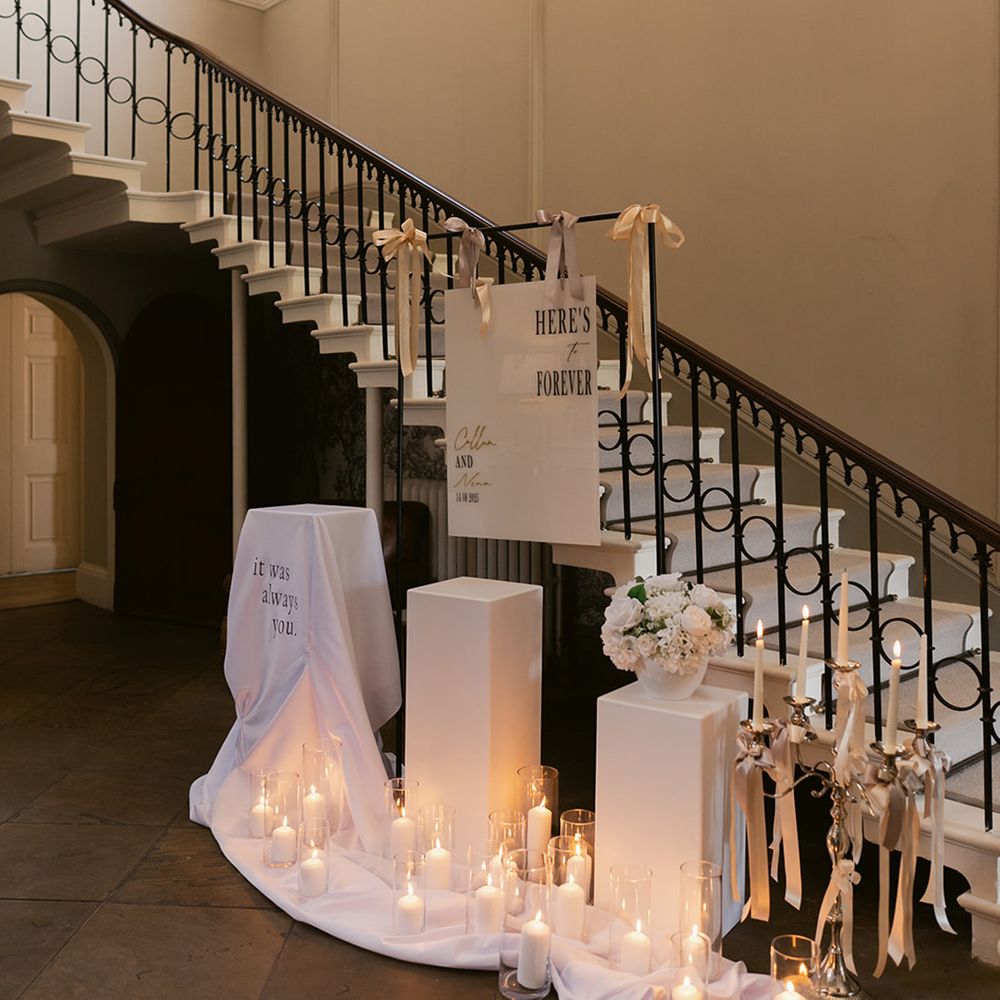 White wedding signage and decorations with candles 
