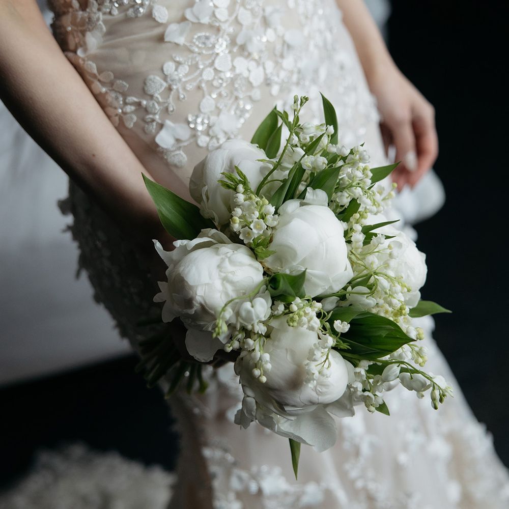 Bride carrying white wedding bouquet