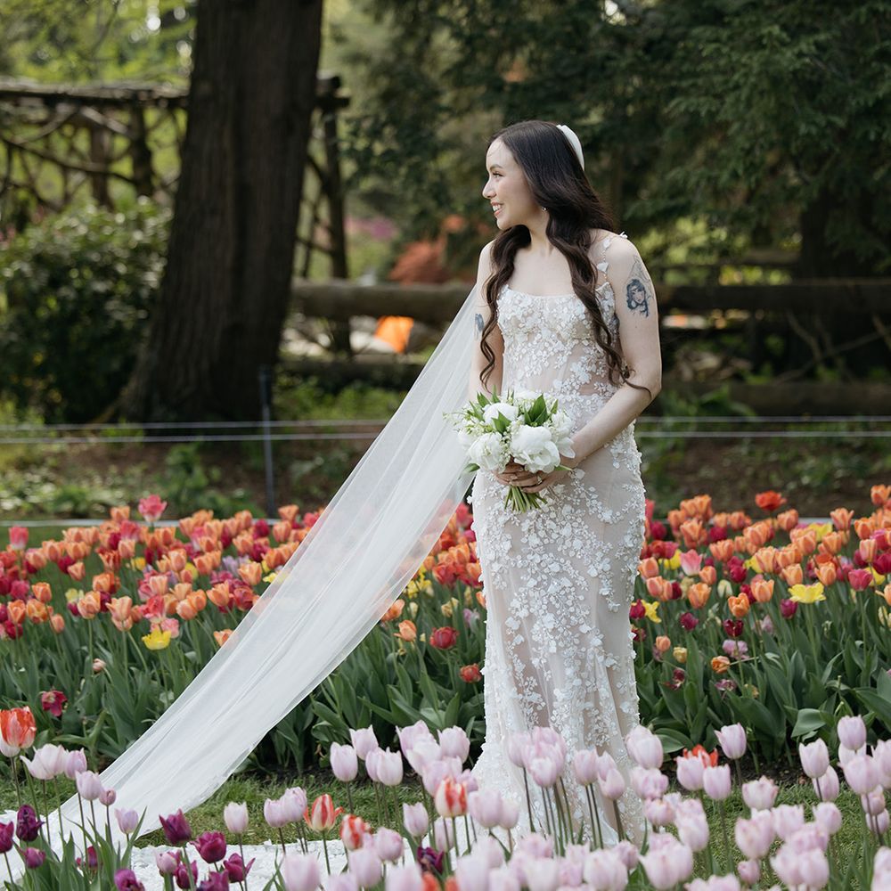 Bride in floral Galia Lahav wedding dress in field of tulips