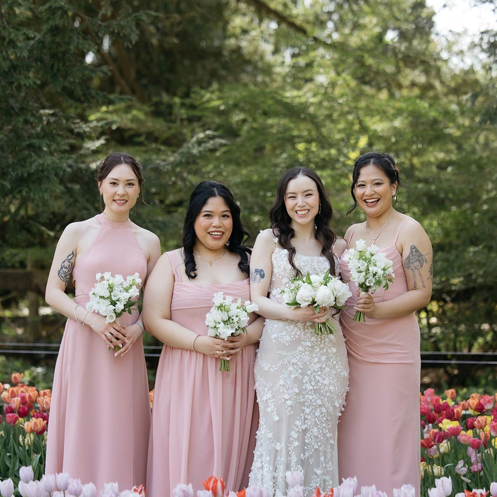 Bridal party in pink bridesmaid dresses with bride 