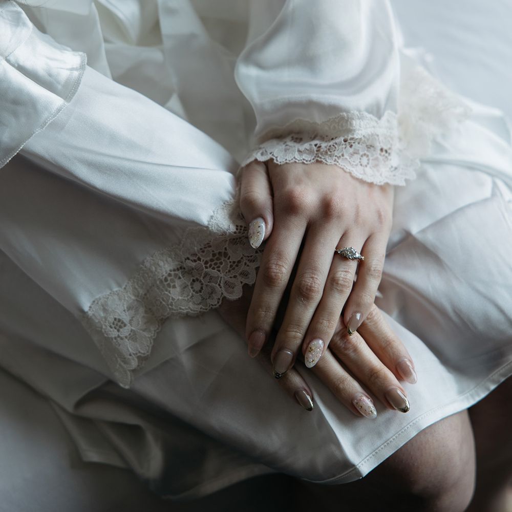 Gold chrome metallic nail art for bride with diamond engagement ring