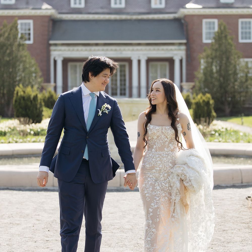Groom in navy suit with bride in Galia Lahav wedding dress