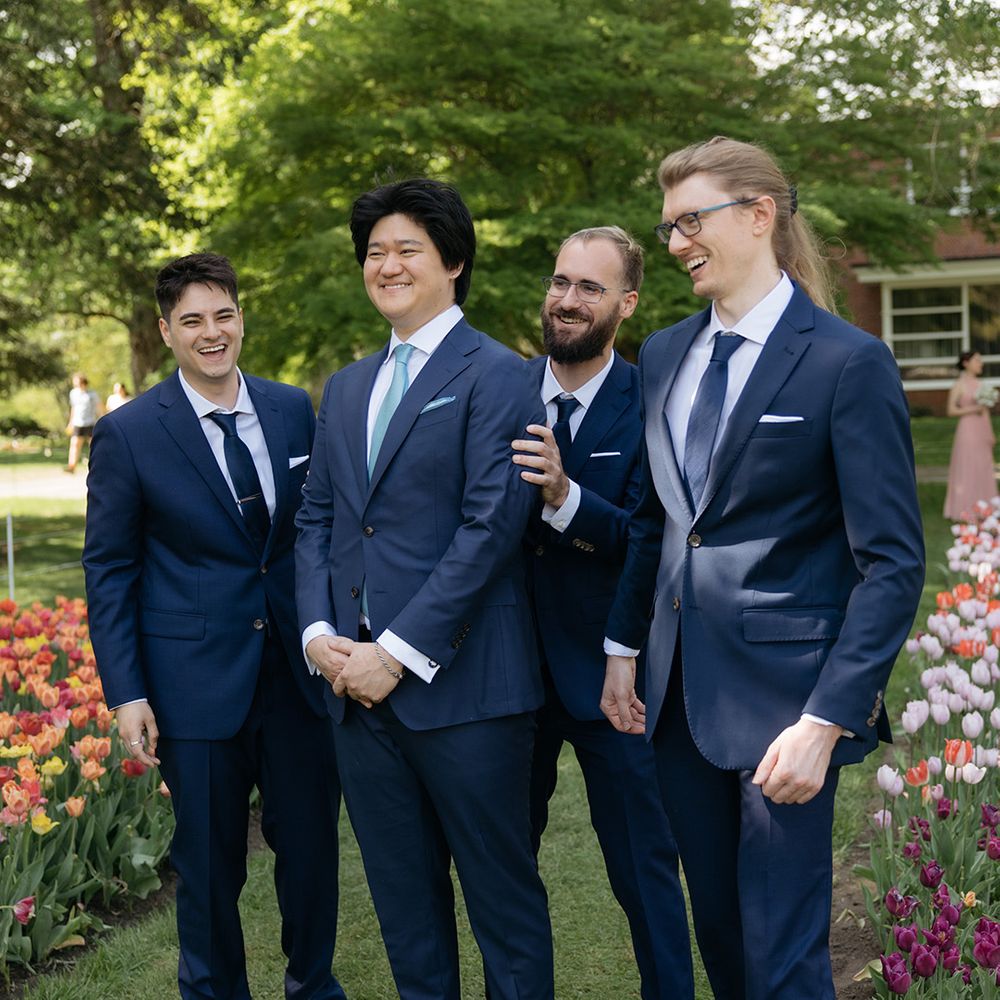 Groomsmen in matching navy wedding suits 