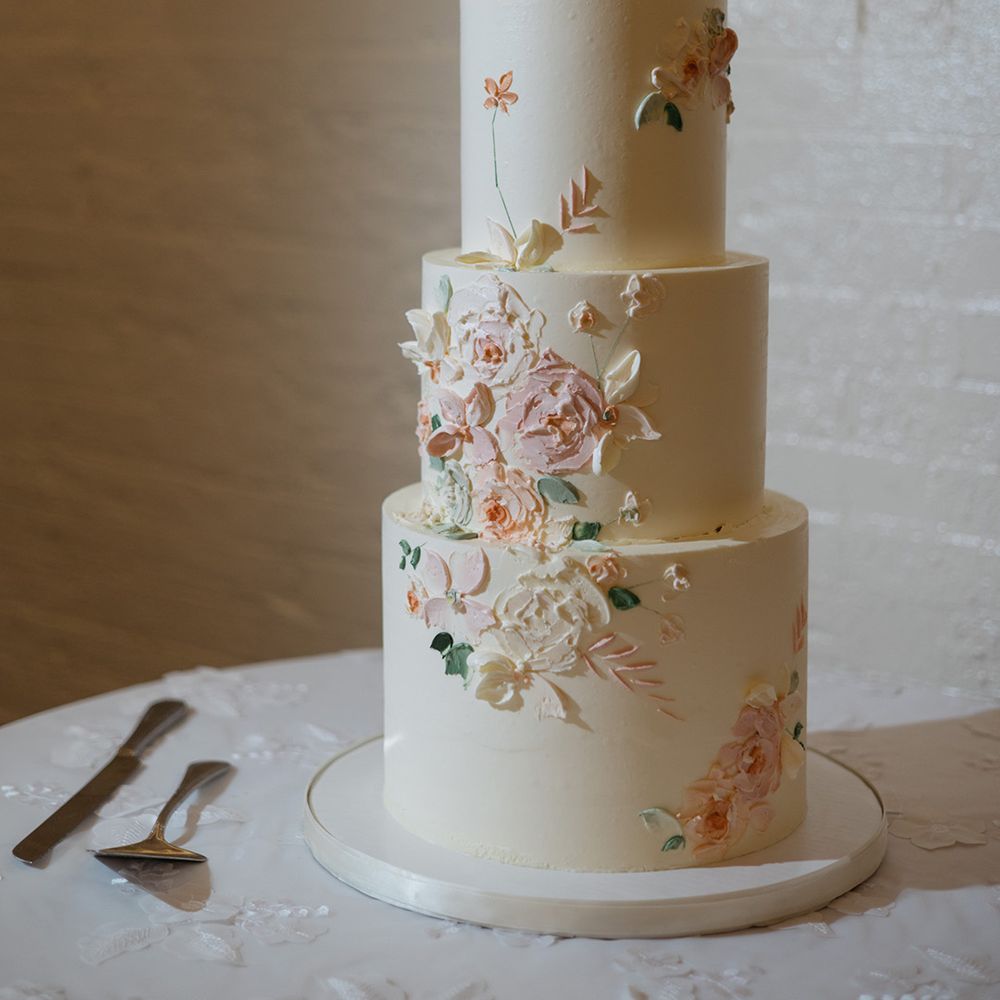 Three tier cream matcha flavoured wedding cake with floral design