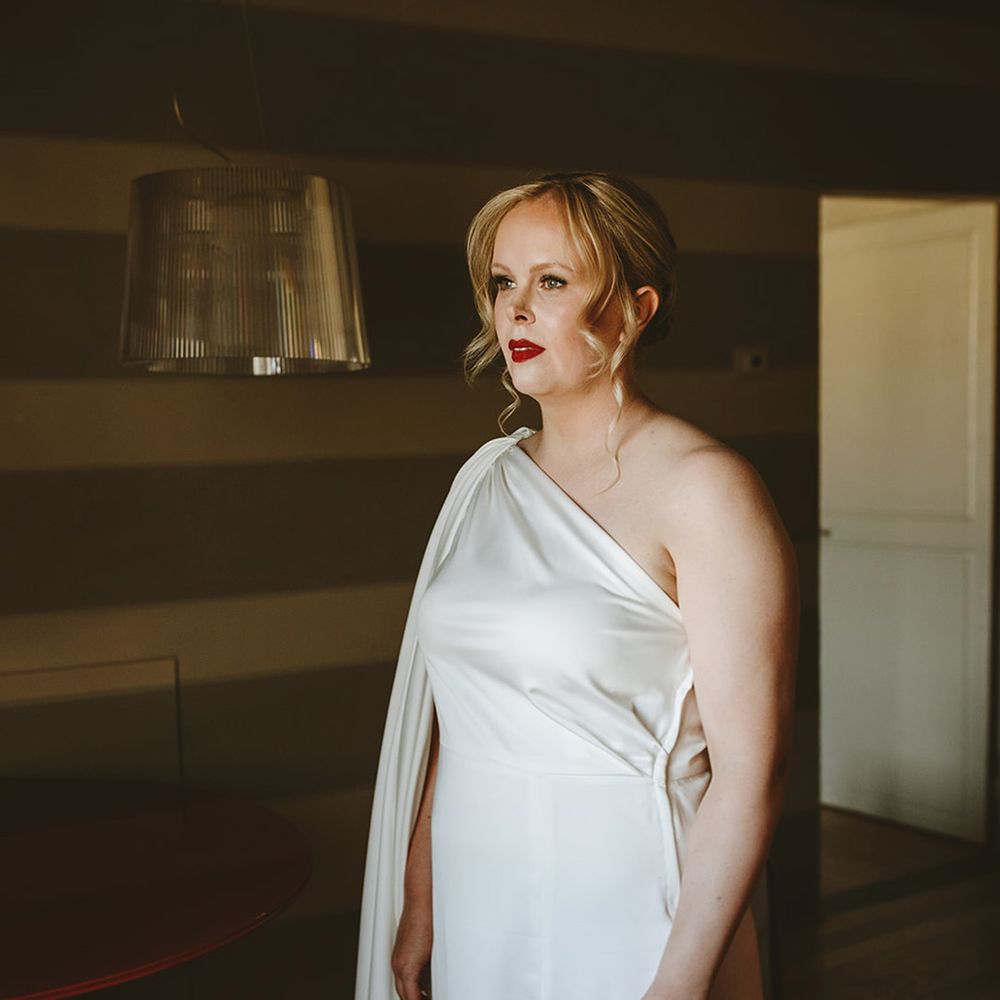 Bride in one shoulder satin wedding dress 