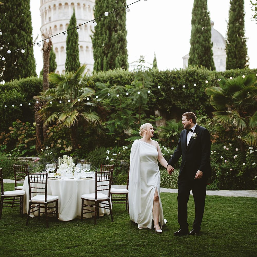 Couple walking around their wedding breakfast set up