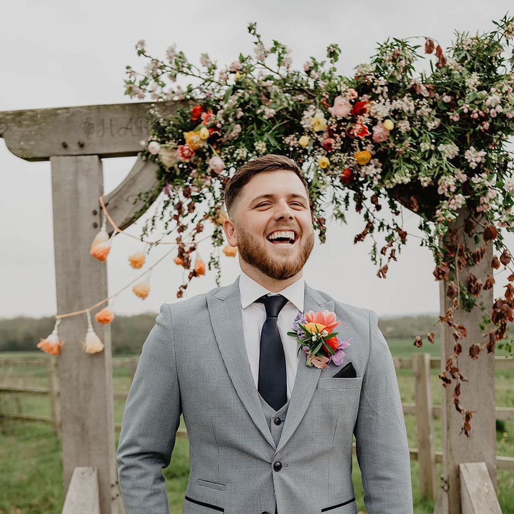 Groom wearing navy blue wedding tie with matching pocket square