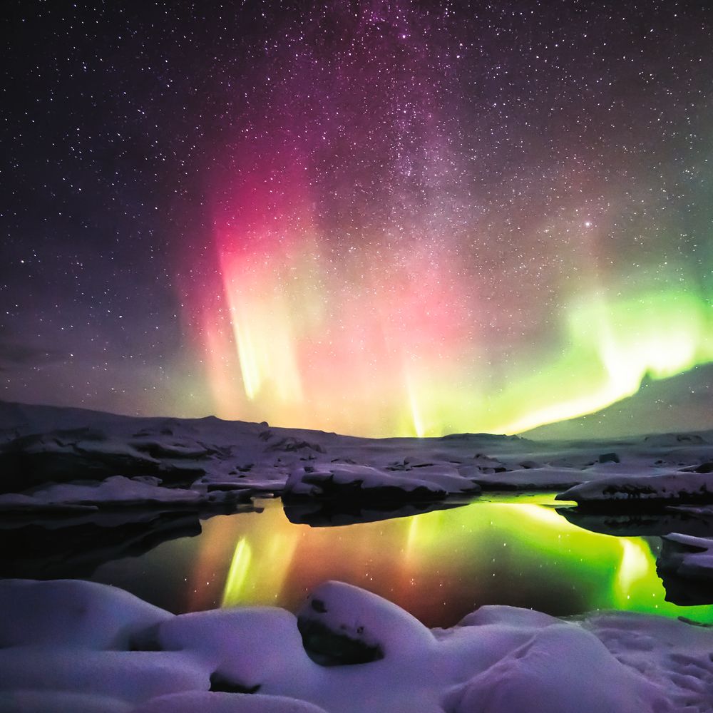 Green and red aurora dancing over the Jokulsarlon lagoon