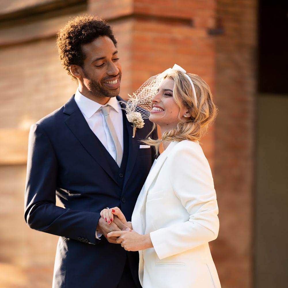 Couple wearing Hockerty and Sumissura custom bride and groom wedding suits