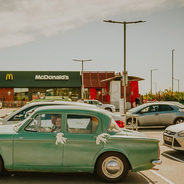 Blue vintage wedding car with white ribbon 