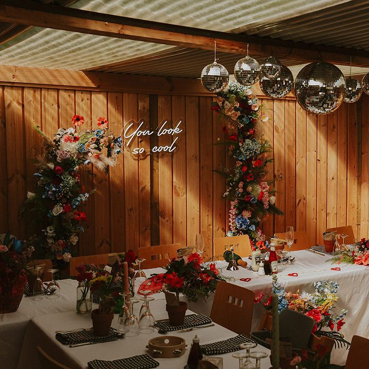 Bright flowers and disco ball wedding breakfast decor 