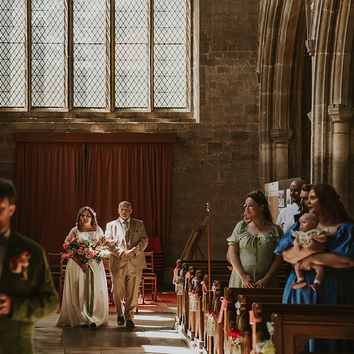 Father of the bride walks bride down the aisle 