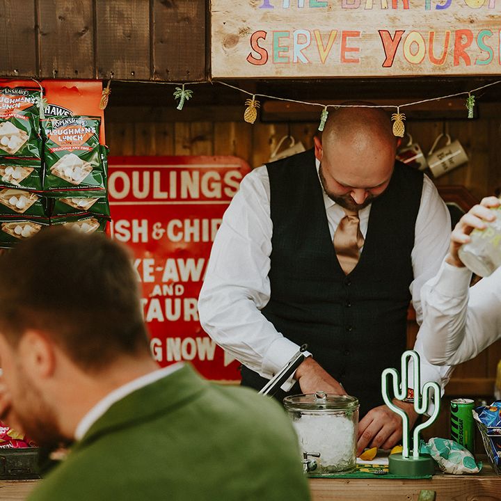 Guests serve themselves at outdoor wedding bar for at home wedding