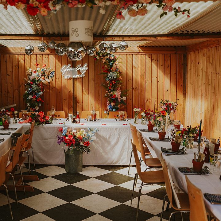 Wedding breakfast set up with disco balls and neon signs