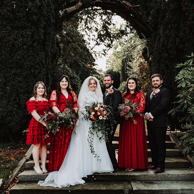 Bridal party in red bridesmaid dresses