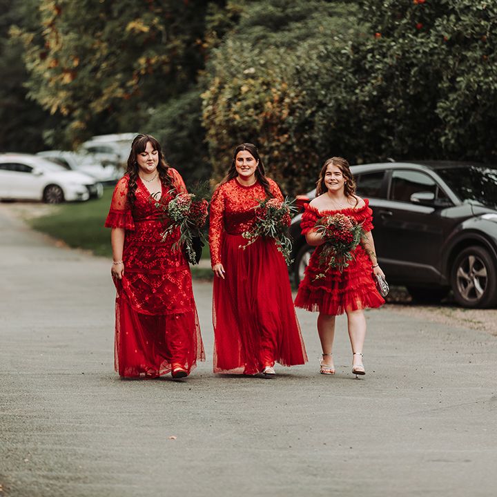 Bridesmaids arrive in red Needle and Thread bridesmaid dresses