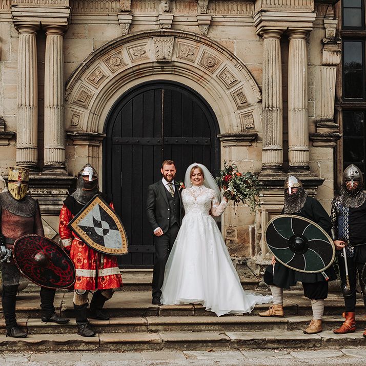 Couple poses with knights at historical wedding 