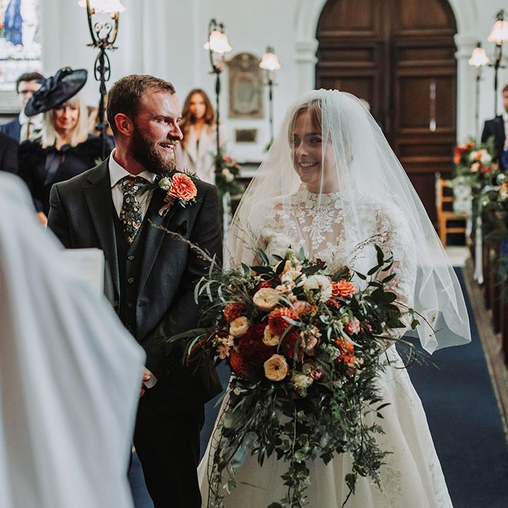 Couple smiles together at wedding ceremony 