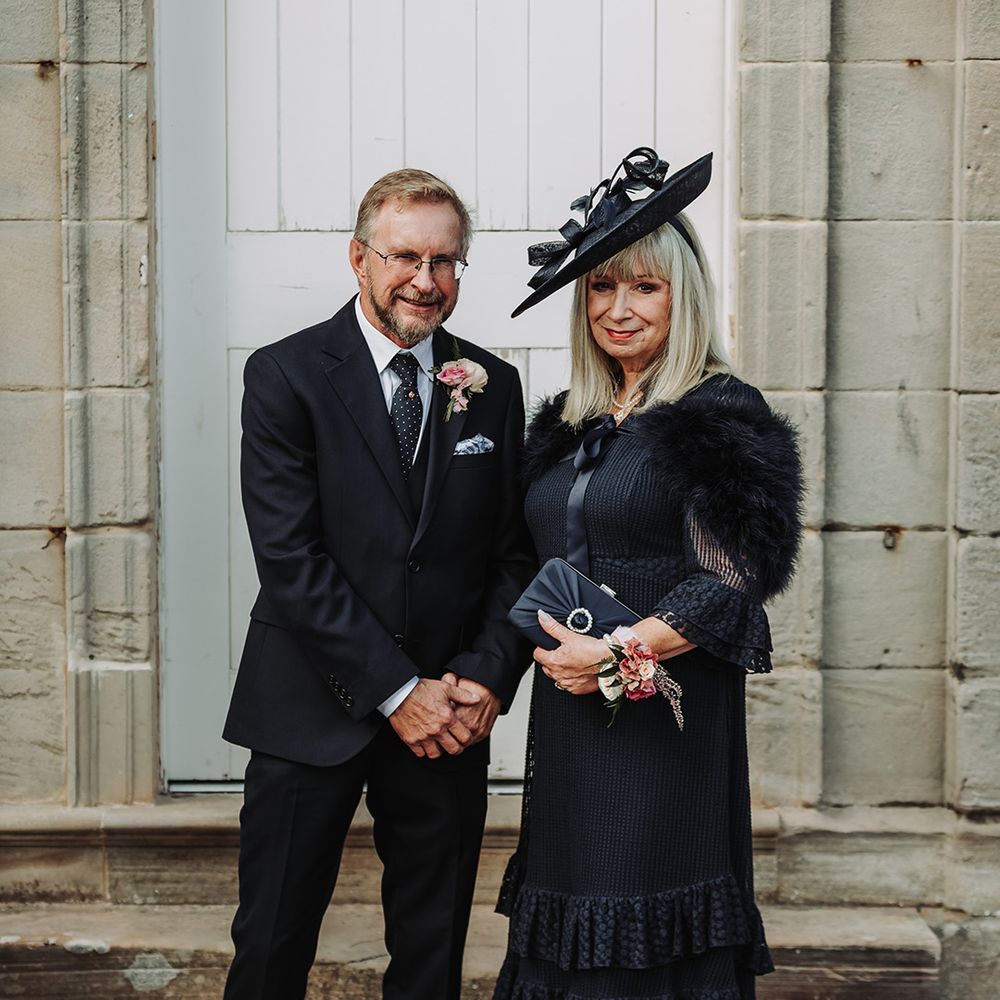 Mother and father of the groom outfits in all black 
